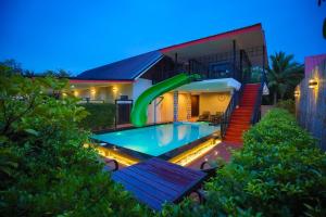 a house with a swimming pool in front of a house at Standard in Ban Phrom Min
