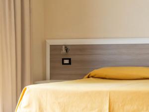 Ein Bett oder Betten in einem Zimmer der Unterkunft Hotel Fabricia