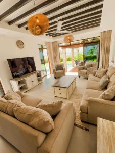 a living room with a couch and a table at Mola Zuri Retreat in Mombasa