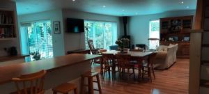 a kitchen and living room with a table and chairs at Woodlands Peaceful Bedrooms in Hemingford Grey