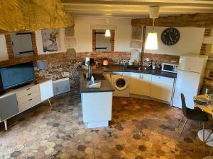 a kitchen with a sink and a dishwasher at Le Colombier d Yville in Héronchelles
