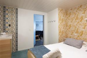 ein Schlafzimmer mit einem Bett und einem Waschbecken darin in der Unterkunft Villa 250m Spa privé, Borne d'arcade, Babyfoot - Gite des frères-Strasbourg in Hurtigheim