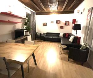 a living room with a couch and a table at Babalù Con vista lago in Arona