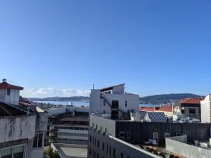 a view of a city with buildings and the water at Ático con terraza en el corazón de Vigo in Vigo