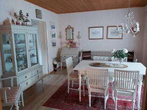 a dining room with a white table and chairs at Koivuharju in Kemi