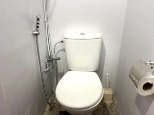 a bathroom with a toilet and a roll of toilet paper at Cosy central studio in Agadir +10 photos