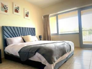 a bedroom with a large bed and a large window at Cosy central studio in Agadir