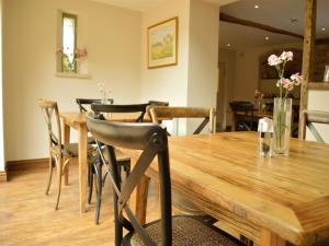 a dining room with a wooden table and chairs at The Plough B&B in Bourton on the Water +6 photos