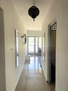a hallway of a home with a chandelier at Cosy calm Studio in the hyper center in Agadir +2 photos