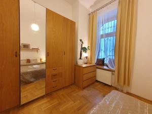 a bedroom with a dresser and a large window at B-4 Kraków Stary Kazimierz O&P ApartFamily in Kraków +26 photos