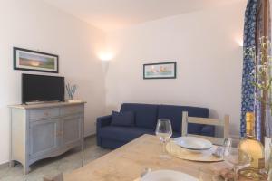 a living room with a blue couch and a table at Palau Green Village in Palau