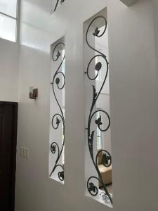 a bathroom with two mirrors on a wall at Rio Grande de Pampanga Villas in Fort Stotsenburg