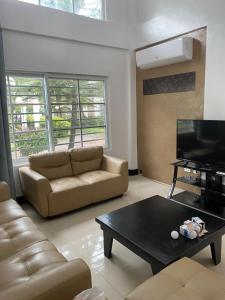 a living room with a couch and a coffee table at Rio Grande de Pampanga Villas in Fort Stotsenburg