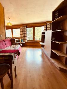 a living room with a couch and a table at Il Cirmolo delle Saline in Falcade