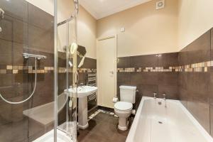 a bathroom with a toilet and a tub and a sink at Langdale Crag in Grasmere +14 photos