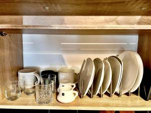 a wooden shelf with plates and glasses on it at Princeps De Cura Gazi in Athens