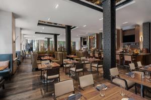 a restaurant with wooden tables and chairs and tables and chairs at JW Marriott Houston Downtown in Houston