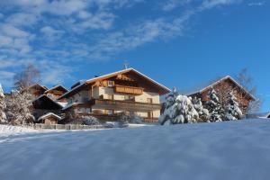 a ski lodge in the snow with snow covered at Kastnerhof in Meltina
