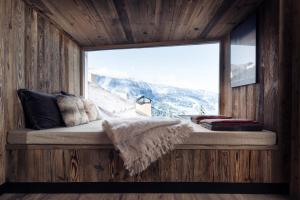 a window seat in a room with a mountain view at Antarès SIRIUS 302 - Ski inski out family apartment in Méribel