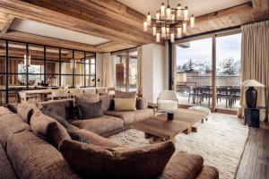 a living room with a large couch and a table at Antarès SIRIUS 201 - Prestigious ski inski out apartment in Méribel