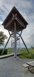 a large wooden structure in the middle of a field at Ferienunterkünfte Schüle in Leibertingen