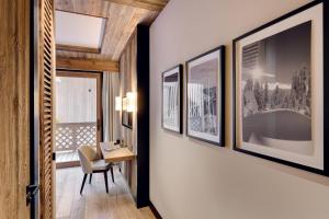 corridoio con scrivania e immagini appese al muro di Antarès NAOS 201 - luxury apartment ski inski out a Méribel