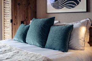 a bunch of pillows sitting on a bed at Antarès URSA 402 - luxury apartment ski inski out in Méribel