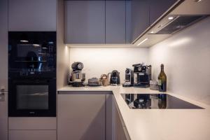 a kitchen with a sink and a stove top oven at Antarès SIRIUS 304 - Spacious ski inski out family apartment in Méribel