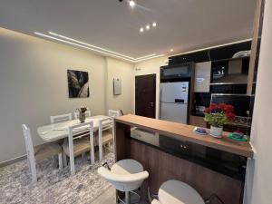 a kitchen and dining room with a table and a dining room at Celia -1 Bedroom Beauty in Madīnat al Amal