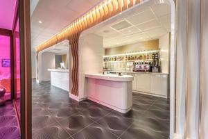 a kitchen with a bar in a room at Prize by Radisson, Antwerp City in Antwerp