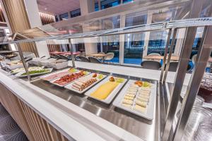a buffet line with many different types of food at Prize by Radisson, Antwerp City in Antwerp