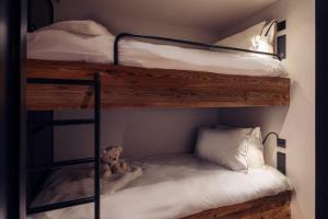 a bedroom with two bunk beds with a teddy bear at Antarès URSA 402 - luxury apartment ski inski out in Méribel