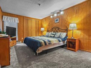 a bedroom with a bed and a flat screen tv at Leatherbark 103A 3BR 2BA Quiet And Serene Private Deck WiFi in Snowshoe