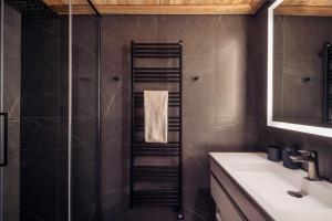 a bathroom with a shower and a sink at Antarès URSA 402 - luxury apartment ski inski out in Méribel +3 photos