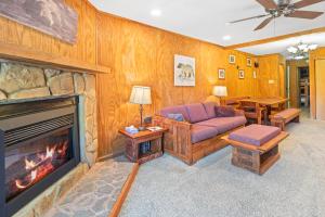 a living room with a couch and a fireplace at Leatherbark 103A 3BR 2BA Quiet And Serene Private Deck WiFi in Snowshoe