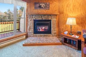 a living room with a fireplace and a window at Leatherbark 103A 3BR 2BA Quiet And Serene Private Deck WiFi in Snowshoe