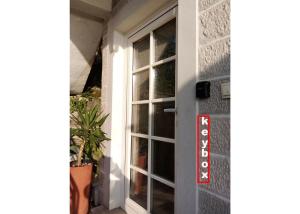 a door with a window on a house at Apartment Mediterraneo Seagull in Perast
