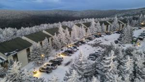 an aerial view of a parking lot with snow covered trees at Leatherbark 103A 3BR 2BA Quiet And Serene Private Deck WiFi in Snowshoe +3 photos