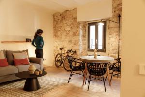 a living room with a couch and a table at La Comuna by Bon Dia Residences in Girona