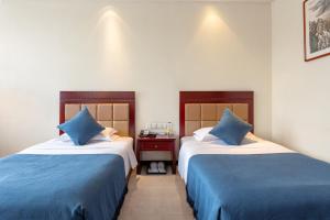 Postel nebo postele na pokoji v ubytování HeBei Cuipingshan Guest House