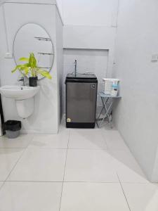 a white bathroom with a sink and a toilet at K Siri House Hatyai in Hat Yai +35 photos
