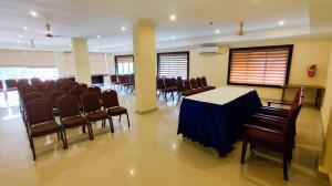a conference room with a table and chairs at HOTEL MEENAKSHI in Kolattupuzha