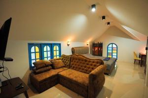 a living room with a couch and a bed at Premium Villa in Ban Khlong Khleng