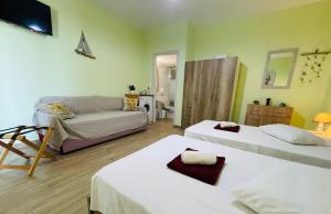 a living room with two beds and a couch at Fergani Apartments in Moúdhros
