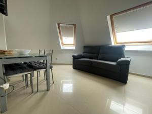 a living room with a couch and a table at Ático centro Ribeira by Cristian&Tamara "alquileres" in Ribeira