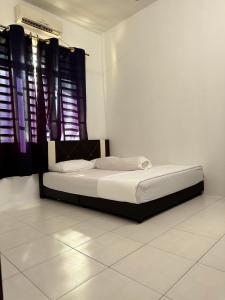 Cama en habitación blanca con cortinas negras en Homestay Kakak Adek with private pool sempadan Perak,Penang dan Kedah, en Bandar Baharu