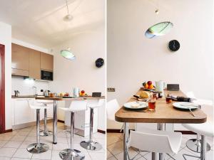 una cucina e una sala da pranzo con tavolo e sedie di Le Quattro Stagioni Lakeview ad Acquaseria