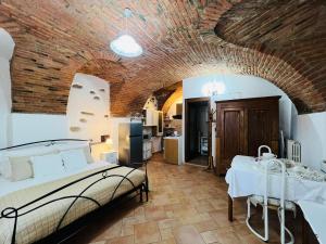 a bedroom with a bed and a brick ceiling at Monolocale Viverone Lake Rooms in Viverone