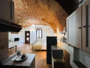 a kitchen and a living room with a bedroom at Monolocale Viverone Lake Rooms in Viverone +17 photos