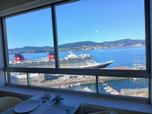 a cruise ship is docked in a harbor at Impresionantes vistas en el centro de Vigo in Vigo